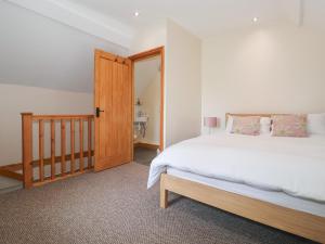 a bedroom with a large bed and a wooden door at Daisy Nook in Hull