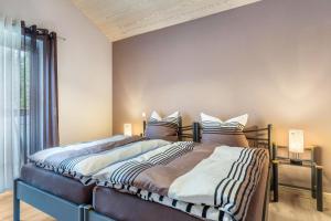 a bedroom with a bed and a large window at Im Rosengarten 3 in Zell am Harmersbach