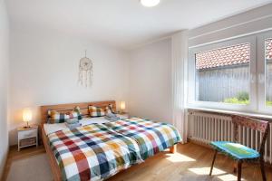a bedroom with a bed and a window at Familie Quednow - Im Algi in Görwihl