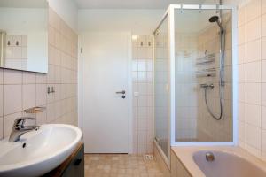 a bathroom with a sink and a shower at Familie Quednow - Im Algi in Görwihl