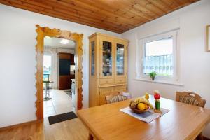 a dining room with a wooden table with a bowl of fruit at Familie Quednow - Im Algi in Görwihl +16 photos
