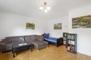 a living room with a couch and a table at Ferienwohnung Eva in Grebenhain