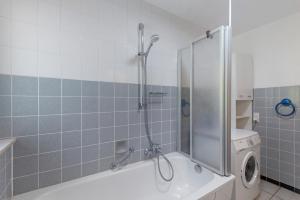 a bathroom with a shower and a washing machine at Ferienwohnung Eva in Grebenhain +21 photos