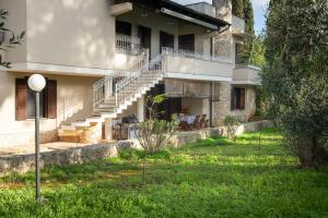 a house with stairs and a grass yard at Casa Cenate Due in Nardò +13 photos