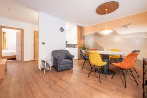 a living room with a table and chairs at App. Miara - Ciasa Lavarella in San Vigilio Di Marebbe