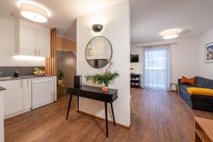 a kitchen and living room with a table in a room at App. Miara - Ciasa Lavarella in San Vigilio Di Marebbe +10 photos