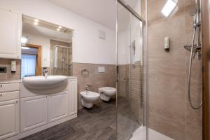 a bathroom with a sink and a toilet and a shower at App. Miara - Ciasa Lavarella in San Vigilio Di Marebbe