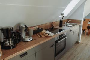 a kitchen with a wooden counter top with a sink at Gästehaus Bröcker Wohnung 7 in Büsum