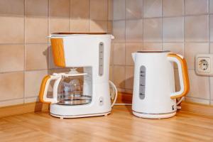 two white coffeemakers sitting on a kitchen counter at Haus Seeadler Wohnung 11 in Koserow