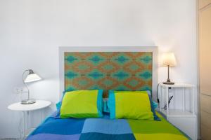 a bedroom with a bed with green and blue at Villa Los Aguacateros in Tazacorte