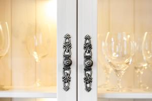 a row of wine glasses in a cabinet at Ferienwohnung an der Volme in Meinerzhagen