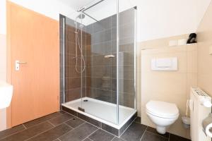 a bathroom with a shower and a toilet at Ferienwohnung Tannenblick 2-2 3-4 in Oberhof +49 photos
