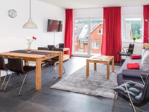 a living room with a table and a couch at Ferienwohnung Tannenblick 2-2 3-4 in Oberhof