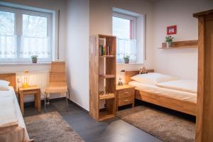 a bedroom with two beds and a book shelf at Ferienwohnung Tannenblick 2-2 3-4 in Oberhof