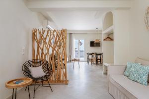 a living room with a couch and a table at Aeolos Villa Erato in Agkidia