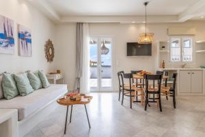 a living room with a couch and a table at Aeolos Villa Erato in Agkidia