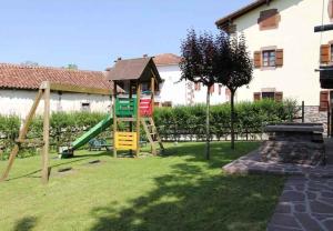 a playground with a slide in a yard at Matxingonea 2 in Urdax