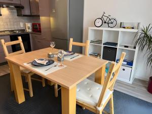 a wooden table in a kitchen with a table and chairs at Petit Bijou in March