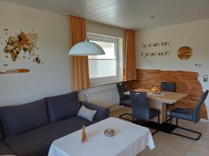 a living room with a couch and a table at Haus Nietmann_ Ferienwohnung 2 in Altenau