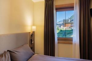 a bedroom with a bed and a window with a view at Villa Elma - Livigno in Livigno