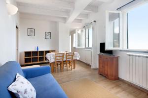 a living room with a blue couch and a table at Casa mare montaretto 1 in Bonassola