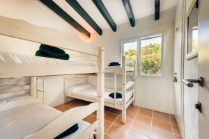 a room with bunk beds and a window at Sa Boga in Cap d'en Font +25 photos