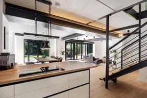 an open kitchen and living room with a staircase at Studio mt nine in Neu Wulmstorf