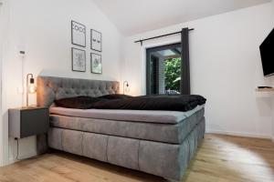 a bedroom with a large bed and a large window at Studio mt nine in Neu Wulmstorf
