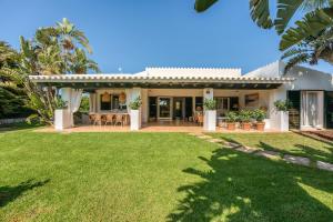 a house with a lawn in front of it at Sa Boga in Cap d'en Font