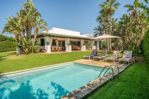 a house with a swimming pool in front of a yard at Sa Boga in Cap d'en Font