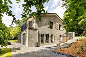 an exterior view of a brick house with a balcony at Studio mt nine in Neu Wulmstorf
