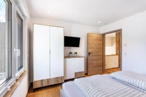 a bedroom with a bed and a flat screen tv at Ferienhaus Wiese in Schmallenberg