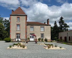 a large house with a lot of plants in front of it at Château De Saint Mayeul in Joze