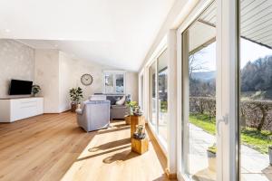 a living room with a couch and a television at Ferienhaus Wiese in Schmallenberg