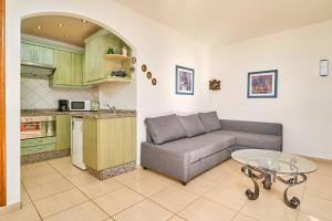 a living room with a couch and a table in a kitchen at Sea Views Centro Internacional A99 in Torrox