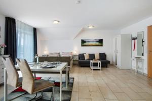 a living room with a table and a couch at Appartement Mia in Ihrlerstein