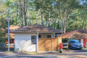 a small house with a car parked in front of it at Saint Amon in Moliets-et-Maa +15 photos
