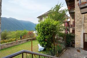 a view from a balcony of a house with a tree at Casa del sole in Toceno