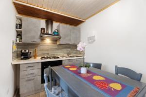 a kitchen with a table and a stove top oven at Casa del sole in Toceno