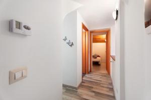 a hallway in a house with white walls and wood floors at Casa del sole in Toceno +17 photos