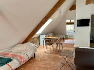 a living room with a couch and a table at Studio Hyper-Centre Villa Isabelle in Allevard
