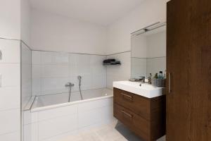 a bathroom with a tub and a sink and a shower at Ferienwohnung Spanier in Pouch +18 photos