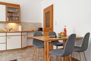 a kitchen with a wooden table and chairs at Mayr Apartments Zwei in Plaus