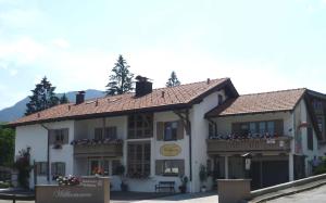 a large white building with windows and balconies at Gästehaus Wolfgang Weitsee in Ruhpolding +9 photos