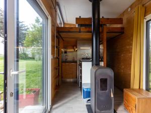 an internal view of a tiny house with a kitchen at La Cafoutche Tiny in Gommenecʼh