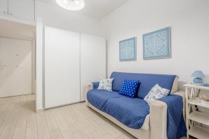 a living room with a blue couch in a room at Studio Flat Blu Palermo Mondello in Palermo +17 photos