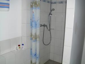 a shower with a shower curtain in a bathroom at Ferienhaus Elfi Mit 85qm in Eisenbach +13 photos