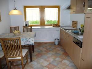 a kitchen with a table and chairs and a sink at Ferienhaus Elfi Mit 85qm in Eisenbach
