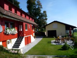 a house with red doors and a yard at Ferienhaus Elfi Mit 85qm in Eisenbach