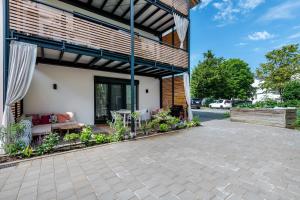 a patio of a house with a table and chairs at bei Thérèse - Große Wohnung Eg in Miltach
